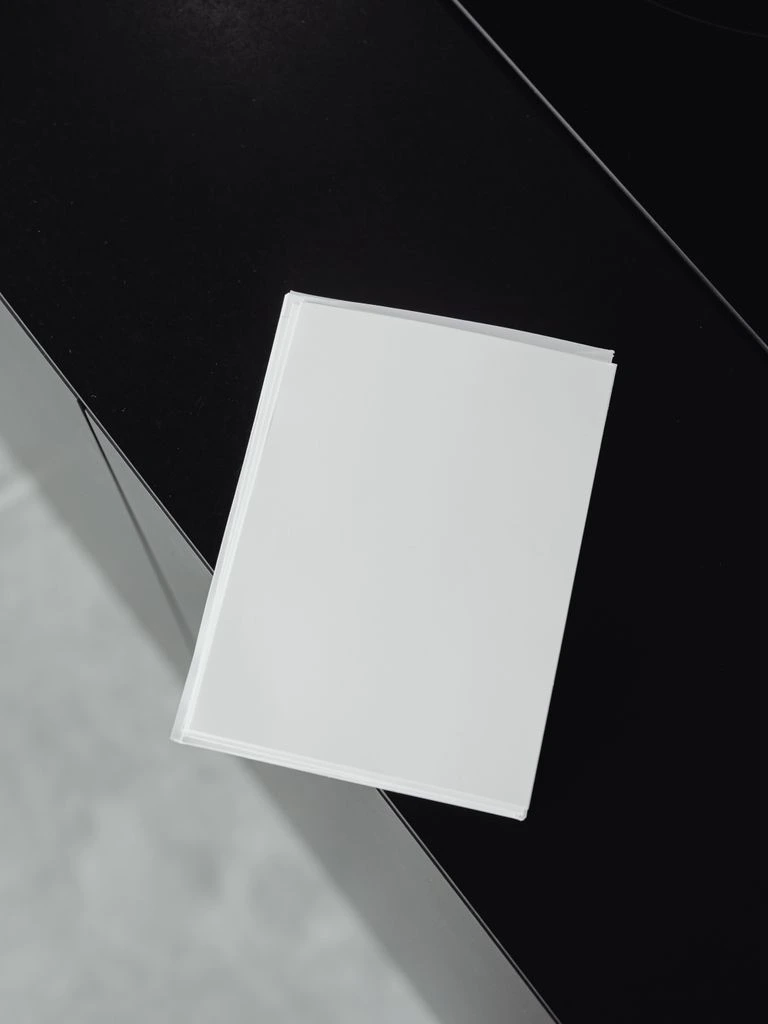 Mockup of the flagship report sitting on a desk with supporting titles stacked beside it